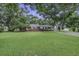 Charming brick home featuring a lush lawn and mature shade trees at 1758 Mendel Rivers Rd, Saint Stephen, SC 29479