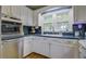 Classic kitchen featuring white cabinetry, stainless steel appliances, and hardwood floors at 1758 Mendel Rivers Rd, Saint Stephen, SC 29479
