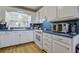 Bright kitchen with white cabinets, blue countertops, and a window offering natural light at 1758 Mendel Rivers Rd, Saint Stephen, SC 29479