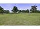 Expansive grassy land featuring green grass and mature trees, providing ample open space at 1758 Mendel Rivers Rd, Saint Stephen, SC 29479