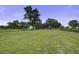 Expansive grassy land featuring green grass and mature trees, providing ample open space at 1758 Mendel Rivers Rd, Saint Stephen, SC 29479