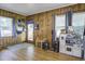 Inviting living room with hardwood floors, wood paneling, and a playful area at 1758 Mendel Rivers Rd, Saint Stephen, SC 29479