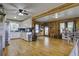 Bright, open living room with wood paneling and an adjacent kitchen area featuring hardwood floors at 1758 Mendel Rivers Rd, Saint Stephen, SC 29479