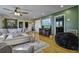 Living room featuring hardwood floors, a modern TV, and cozy furniture at 1758 Mendel Rivers Rd, Saint Stephen, SC 29479