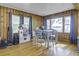 Charming living room with wood paneling, hardwood floors, and large windows offering beautiful views at 1758 Mendel Rivers Rd, Saint Stephen, SC 29479