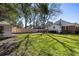 Large backyard with a lush lawn, brick patio, and guest house at 18 Sothel Ave, Charleston, SC 29407