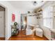 Bright breakfast nook with floating shelves, modern lighting, and a unique round table with three cushioned ottomans at 18 Sothel Ave, Charleston, SC 29407