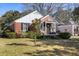 Brick home with black shutters and front yard with green grass, showcasing its curb appeal at 18 Sothel Ave, Charleston, SC 29407