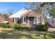 Charming brick home featuring black shutters, manicured landscaping, and a cozy front porch at 18 Sothel Ave, Charleston, SC 29407