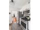 Modern kitchen featuring stainless steel appliances, white cabinets, and grey tiled floors at 18 Sothel Ave, Charleston, SC 29407