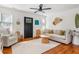 Bright living room with hardwood floors, neutral furniture, and a ceiling fan at 18 Sothel Ave, Charleston, SC 29407