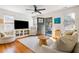 Living room with hardwood floors, a TV, neutral seating, and bright natural light at 18 Sothel Ave, Charleston, SC 29407