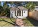 Exterior of backyard outbuilding with brick pathway surrounded by green grass at 18 Sothel Ave, Charleston, SC 29407