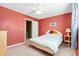 Cozy bedroom with red walls, ceiling fan, and ample natural light from the window at 1860 Mepkin Rd # H1, Charleston, SC 29407