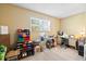 Neutral-toned bedroom with large window, fan, and space for a home office setup at 1860 Mepkin Rd # H1, Charleston, SC 29407