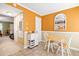 Charming dining area with light wood table, chairs, and stylish wall mirror at 1860 Mepkin Rd # H1, Charleston, SC 29407