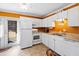 Bright kitchen featuring white appliances, cabinetry, and a door to the exterior at 1860 Mepkin Rd # H1, Charleston, SC 29407