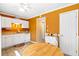 Cozy eat-in kitchen with white appliances and bright orange walls, filled with natural light at 1860 Mepkin Rd # H1, Charleston, SC 29407
