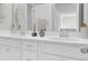 Bright bathroom with double sinks, white cabinetry, and a large mirror at 2021 Quiet Ibis Rd, Hanahan, SC 29410