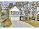 Charming two-story home with a well-manicured lawn and attached two-car garage at 2021 Quiet Ibis Rd, Hanahan, SC 29410