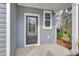 Front entry door of home with covered entryway, gray siding and white trim at 2021 Quiet Ibis Rd, Hanahan, SC 29410