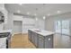 Modern kitchen featuring white cabinets, stainless steel appliances, and gray kitchen island at 2021 Quiet Ibis Rd, Hanahan, SC 29410
