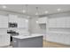 Well-lit kitchen with white cabinets, stainless steel appliances, and a gray island at 2021 Quiet Ibis Rd, Hanahan, SC 29410