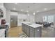Bright kitchen with a gray island, stainless steel appliances, and a view to the outdoors at 2021 Quiet Ibis Rd, Hanahan, SC 29410