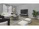 Bright living room with a white couch, patterned rug, and large windows with natural light at 2021 Quiet Ibis Rd, Hanahan, SC 29410