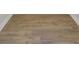 Close up on light brown, wood-like flooring, which is waterproof and durable at 2021 Quiet Ibis Rd, Hanahan, SC 29410