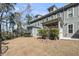 View of the backyard featuring a screened in porch and tree lined border at 2322 Watchtower Ln, Charleston, SC 29414