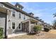 Back exterior of townhomes with patio and screened in porches on well manicured lawn at 2322 Watchtower Ln, Charleston, SC 29414