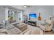 Cozy living room with plush sectional, natural light and stylish decor elements at 2322 Watchtower Ln, Charleston, SC 29414