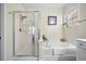 Comfortable bathroom featuring a shower over tub with glass doors and a large window at 240 Gazania Way, Charleston, SC 29414