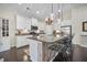 Kitchen island with barstool seating, granite countertop, and pendant lighting at 240 Gazania Way, Charleston, SC 29414