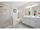 Well-lit primary bathroom with a walk-in shower, soaking tub, and dual vanity sinks at 240 Gazania Way, Charleston, SC 29414