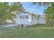 Spacious backyard featuring mature trees and green grass with home and patio area in view at 2673 Olympia Ave, North Charleston, SC 29405
