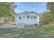 Large backyard featuring a home with a side patio, room for recreation, and mature trees at 2673 Olympia Ave, North Charleston, SC 29405