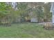 Expansive backyard showcasing mature trees and an outbuilding perfect for gardening and storage at 2673 Olympia Ave, North Charleston, SC 29405