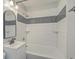 Updated bathroom featuring subway tile, updated fixtures, a tiled shower with built-in shelving, and modern mirror at 2673 Olympia Ave, North Charleston, SC 29405