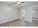Bedroom features wood grain floors, ceiling fan, and view into adjoining bathroom at 2673 Olympia Ave, North Charleston, SC 29405