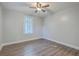 Neutral bedroom features wood grain floors, ceiling fan, and bright window with natural light at 2673 Olympia Ave, North Charleston, SC 29405