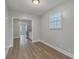 Bright dining room with wood grain floors, window, and adjoining view into the kitchen at 2673 Olympia Ave, North Charleston, SC 29405