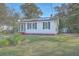 Exterior view of home with solar panels, screened-in front porch and storage shed at 2673 Olympia Ave, North Charleston, SC 29405