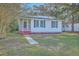 Inviting exterior of home with a cozy screened porch and solar panels on the roof at 2673 Olympia Ave, North Charleston, SC 29405