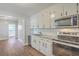 Modern kitchen features stainless steel appliances, granite countertops, and white cabinets at 2673 Olympia Ave, North Charleston, SC 29405