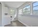 Spacious laundry room area with multiple windows for natural light and crisp white cabinets and appliances at 2673 Olympia Ave, North Charleston, SC 29405