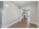 Open living room with gray walls, wood grain floors, and doorway to kitchen and dining space at 2673 Olympia Ave, North Charleston, SC 29405