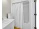 Bathroom with a white vanity, shower-tub combination with a curtain and white trim at 2710 Laroche St, Edisto Beach, SC 29438
