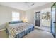 Cozy bedroom with a patterned bed, access to the outdoor porch and lots of natural light at 2710 Laroche St, Edisto Beach, SC 29438